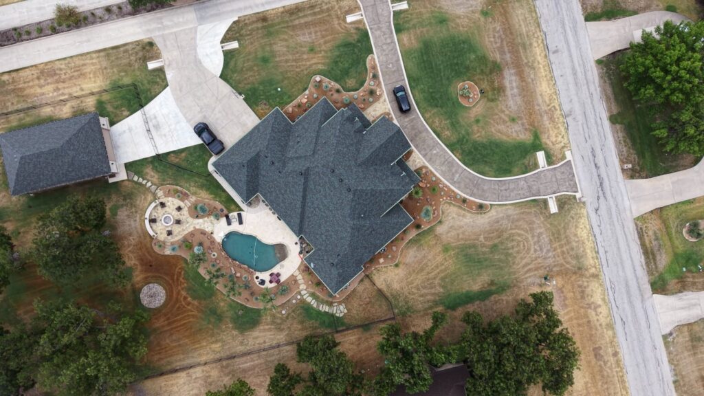 Drone view of a new asphalt shingle roof on a DFW home