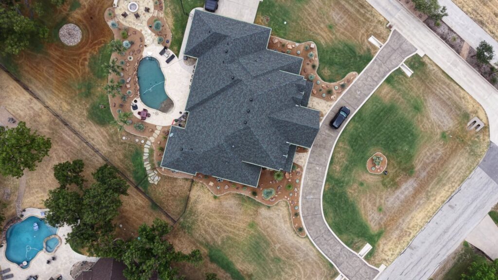 Overhead drone photo of a finished residential roof replacement near Fort Worth