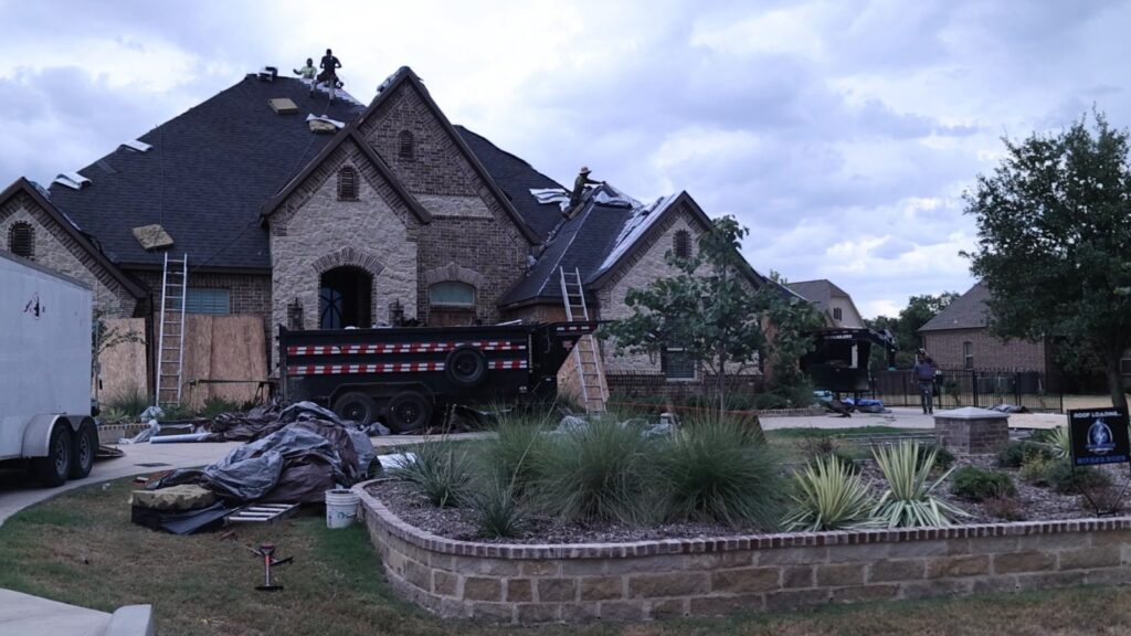 Prometheus Power Solutions crew replacing a roof on a brick home in North Texas