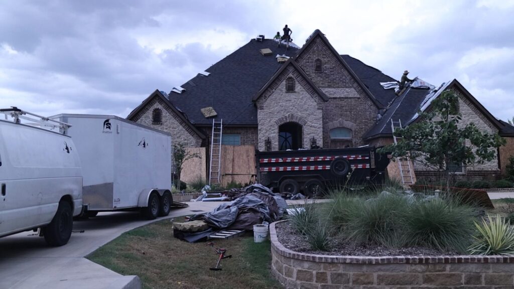 Roof replacement in progress on a DFW home with a dump trailer and materials on site
